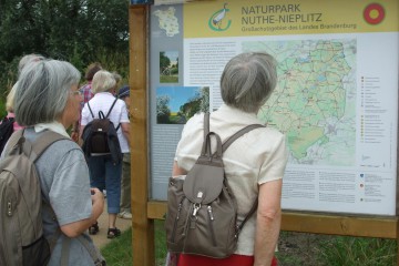 Besucher informieren sich an einer Schautafel über den Naturpark © Katrin Rospek